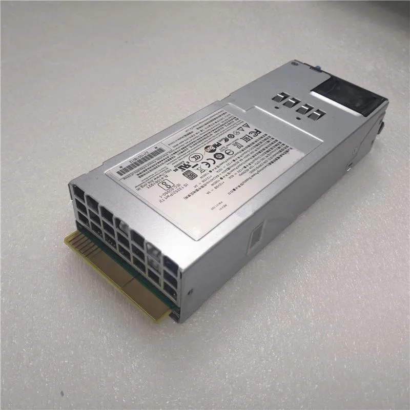 Rectangular silver metal power supply unit with ventilation grille and label