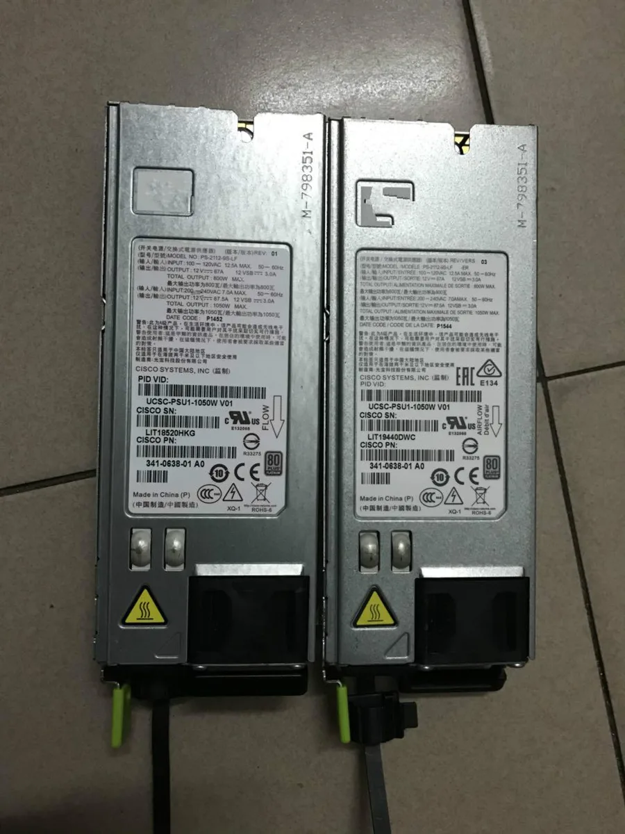 Rectangular silver server power supply unit with rear fan grille and power connector