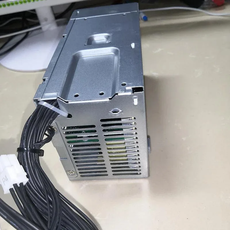 Rectangular silver ATX power supply unit with ventilation grille and fan visible
