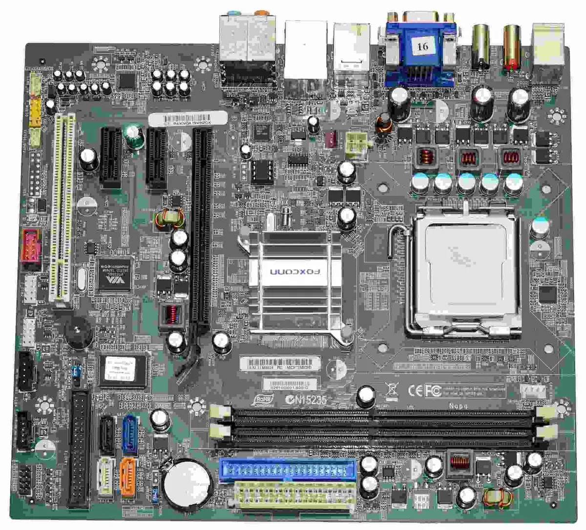 Green rectangular desktop motherboard with silver sockets and chips