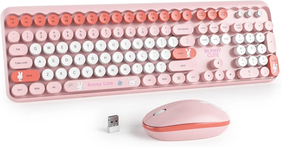 Pink full-size wireless keyboard with round retro keycaps and matching mouse, USB receiver shown