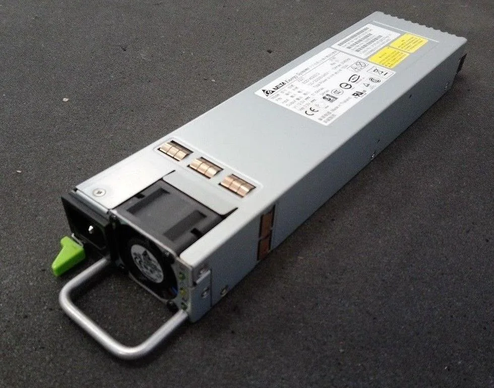 Silver rectangular ATX power supply unit with ventilation grille and power socket