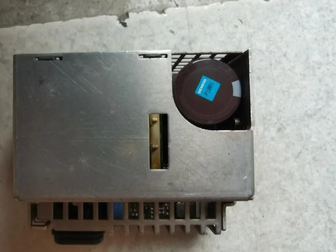 Silver ATX industrial power supply unit with cooling fan grille