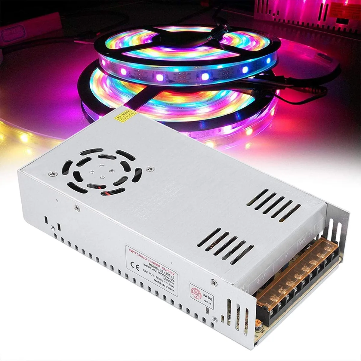Pink rectangular metal power supply unit with screw terminals and ventilation slots