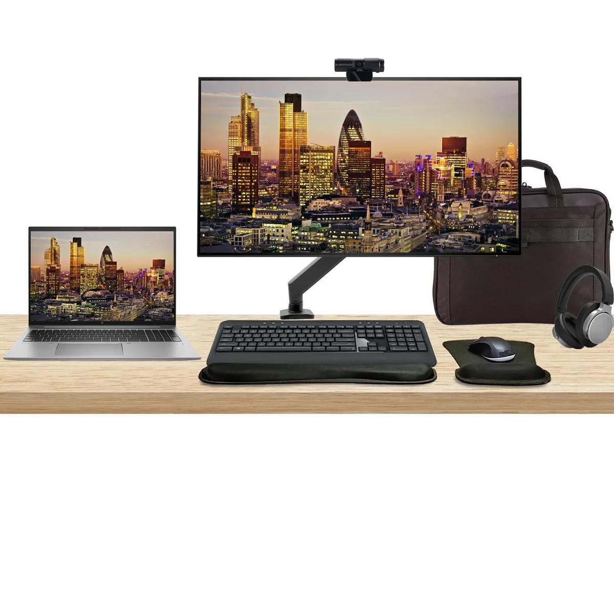 A silver 16 inch laptop, a black 32 inch 4K monitor on an adjustable arm, wireless keyboard and mouse, webcam