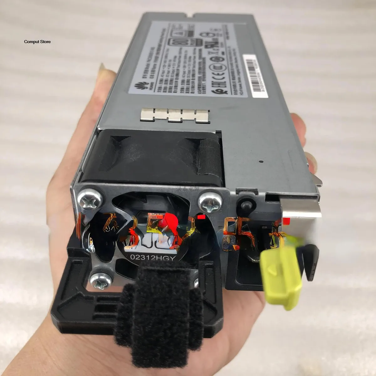 Rectangular silver ATX power supply module with fan grille and rear connector panel