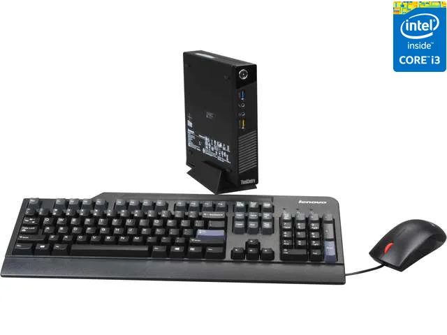Small square black desktop computer with a full-size USB keyboard