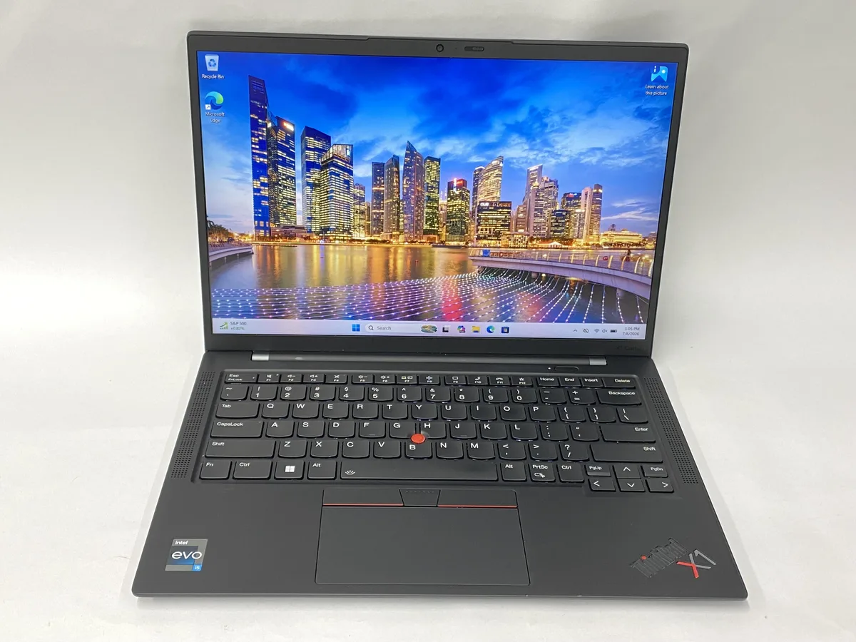 Slim silver laptop with 14 inch matte display, thin bezels, open lid showing keyboard and trackpad
