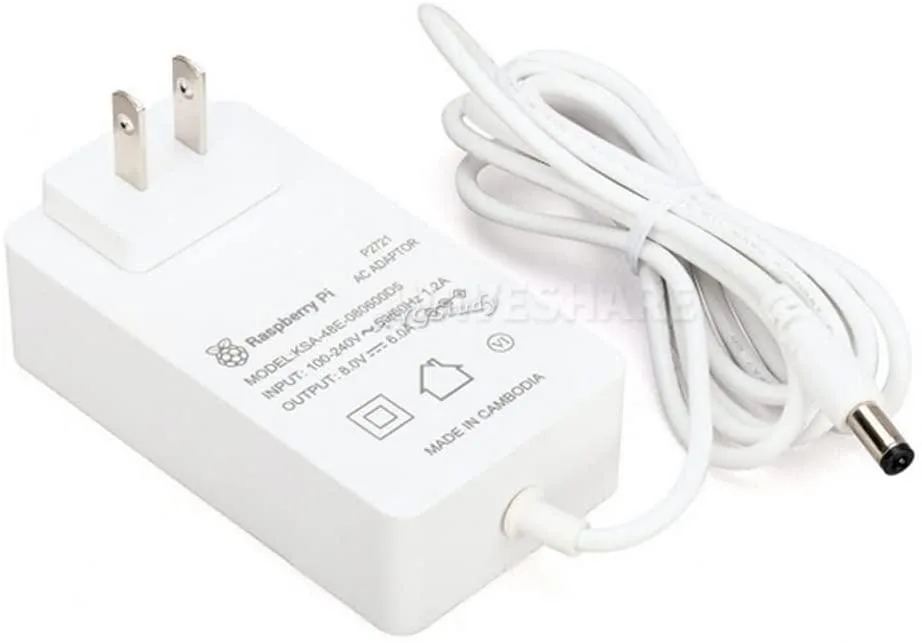 Black rectangular power brick with DC2.1 barrel connector and US plug prongs