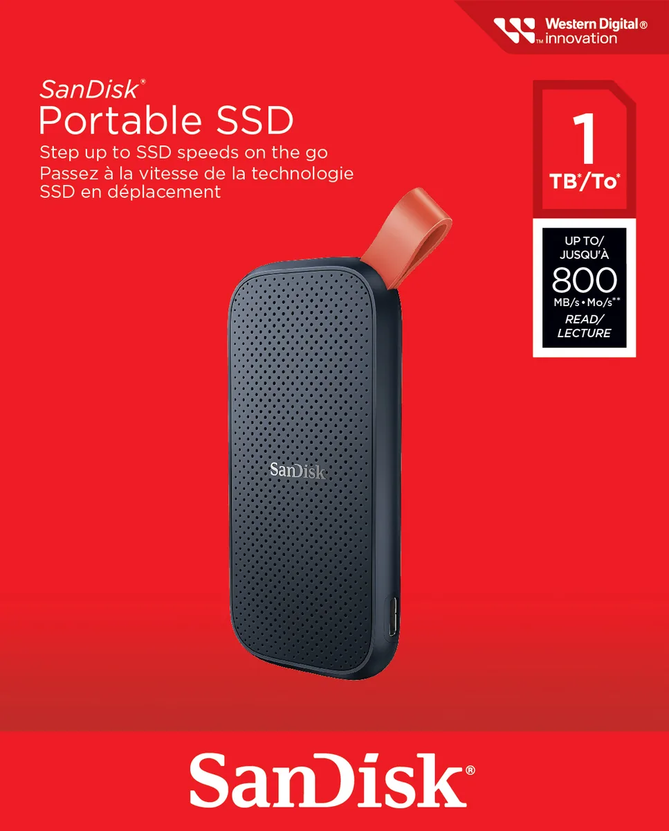 Compact rectangular portable SSD with rounded edges, black matte finish and orange rubber hook loop