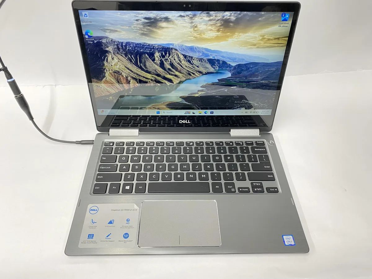 Silver Dell Inspiron 13 7000 2-in-1 laptop open showing 13 inch touchscreen