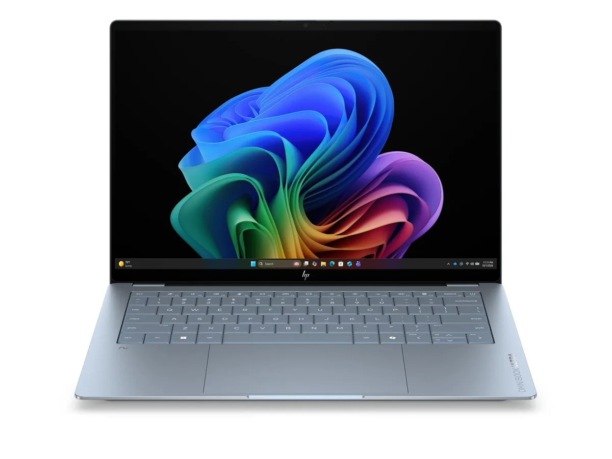 Thin silver aluminium laptop with 14 inch OLED touchscreen, flat hinge, minimal bezels