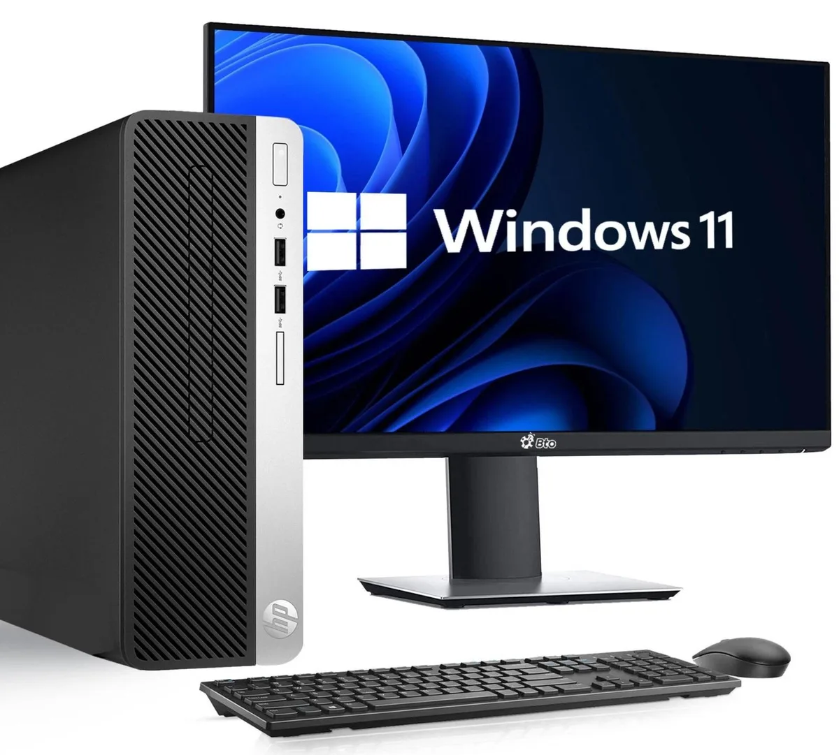 Compact black small-form-factor tower beside a 24-inch monitor with keyboard and mouse