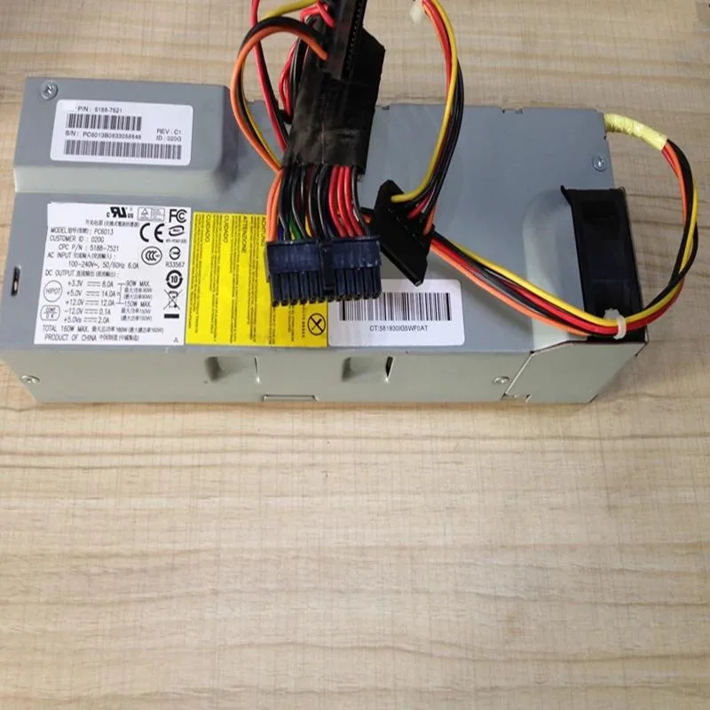 Compact silver ATX power supply unit with rear fan grille and cable bundle
