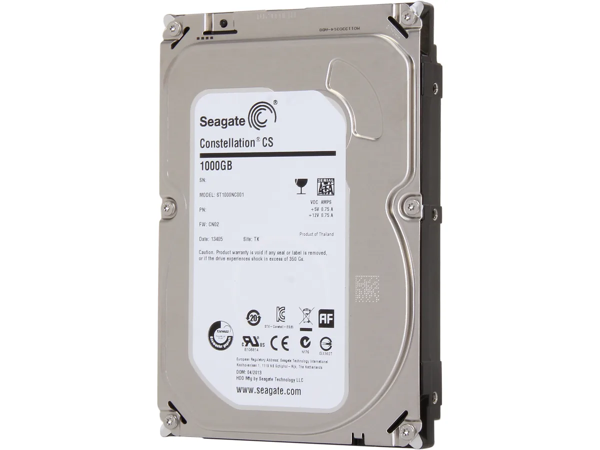 Silver 3.5 inch bare hard drive with green circuit board visible