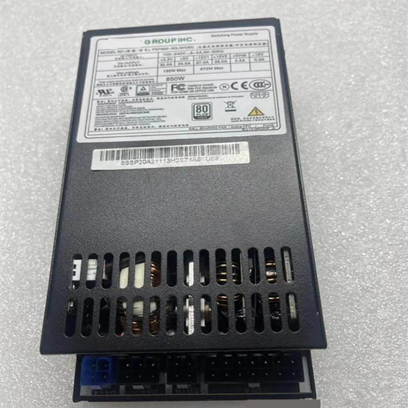 Silver rectangular Flex ATX power supply unit with black fan grille and label sticker