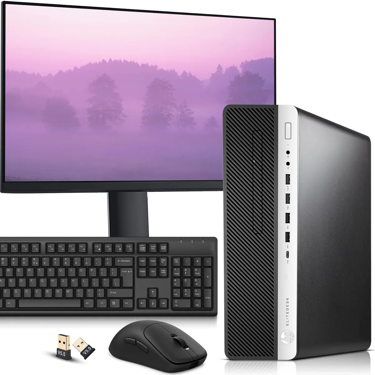 Black small-form-factor desktop tower beside a 24-inch monitor with wireless keyboard and mouse