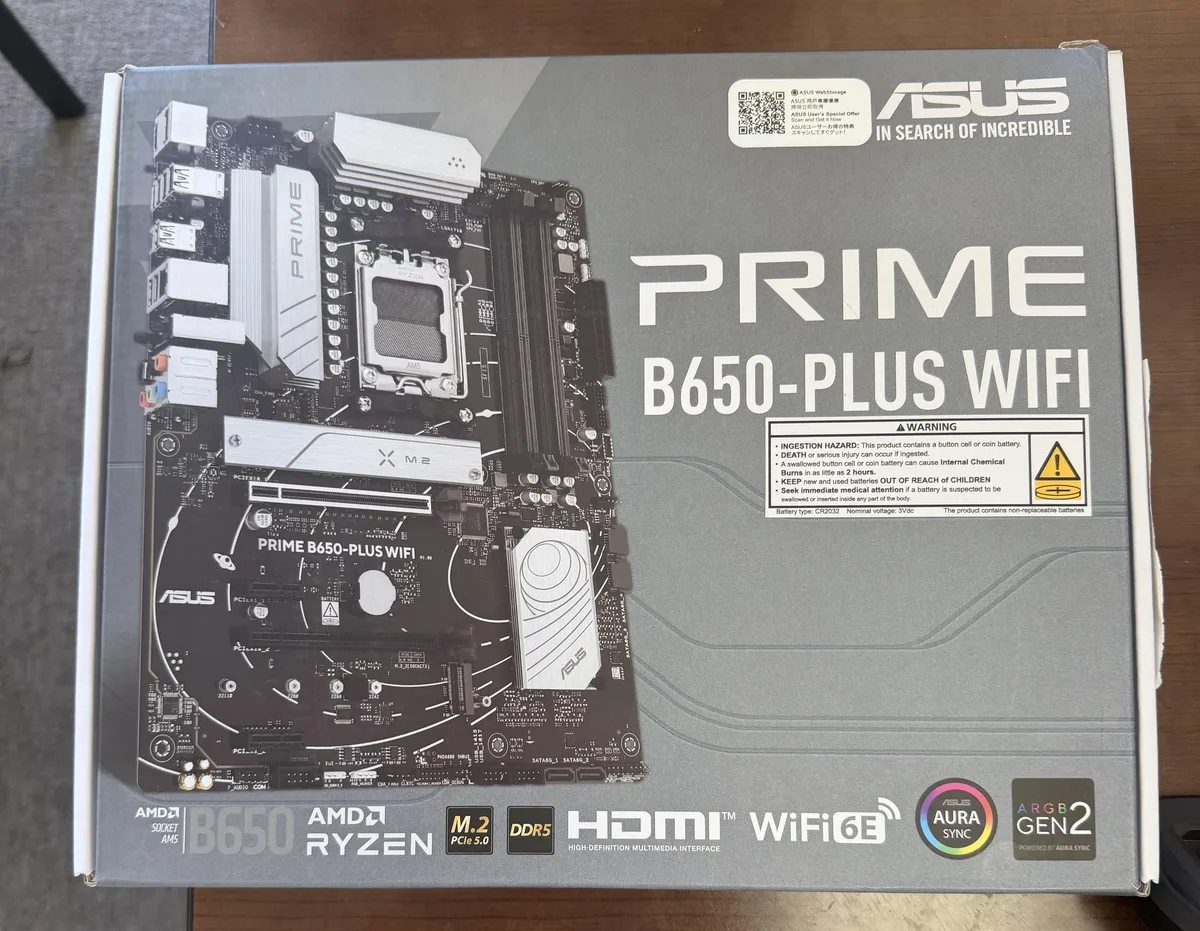 ATX motherboard in matte black with silver VRM and chipset heatsinks, four DDR5 slots, PCIe x16 slot, M.2 shield