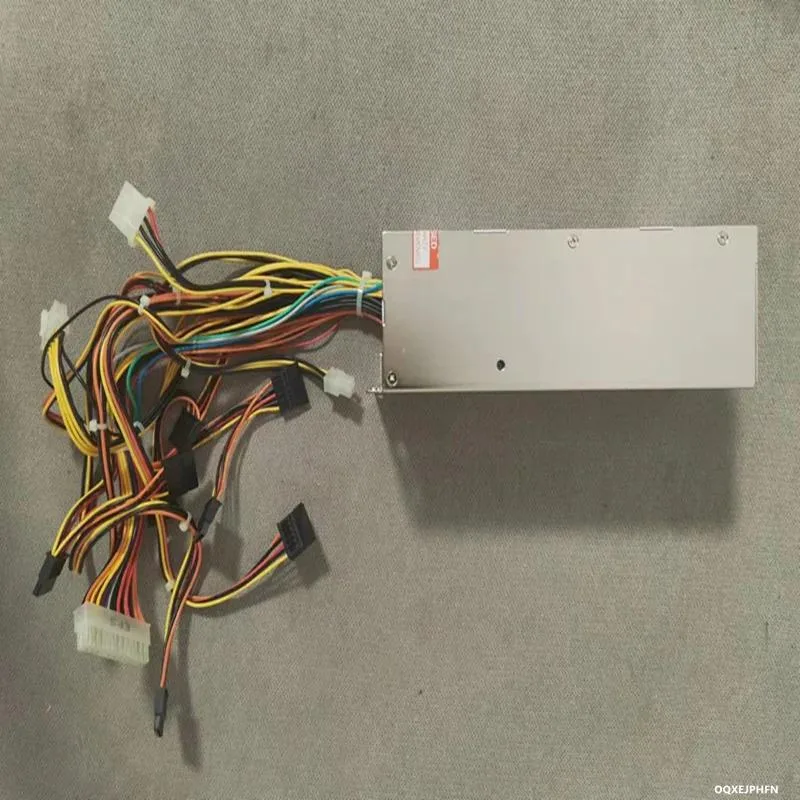 Silver 2U ATX power supply unit with rear fan grille and cable connectors