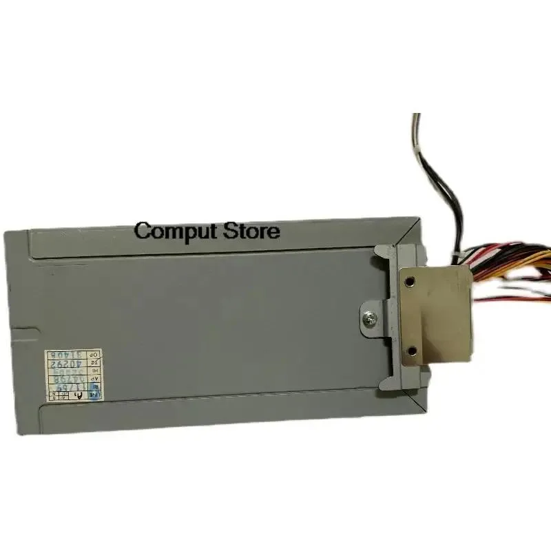 Rectangular silver ATX power supply unit with ventilation grille and label showing model numbers