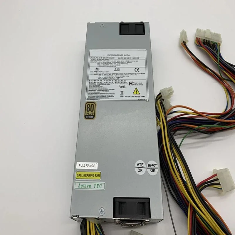 Rectangular metal ATX power supply unit, matte black finish, cooling fan visible on one side, modular cable connectors on the rear