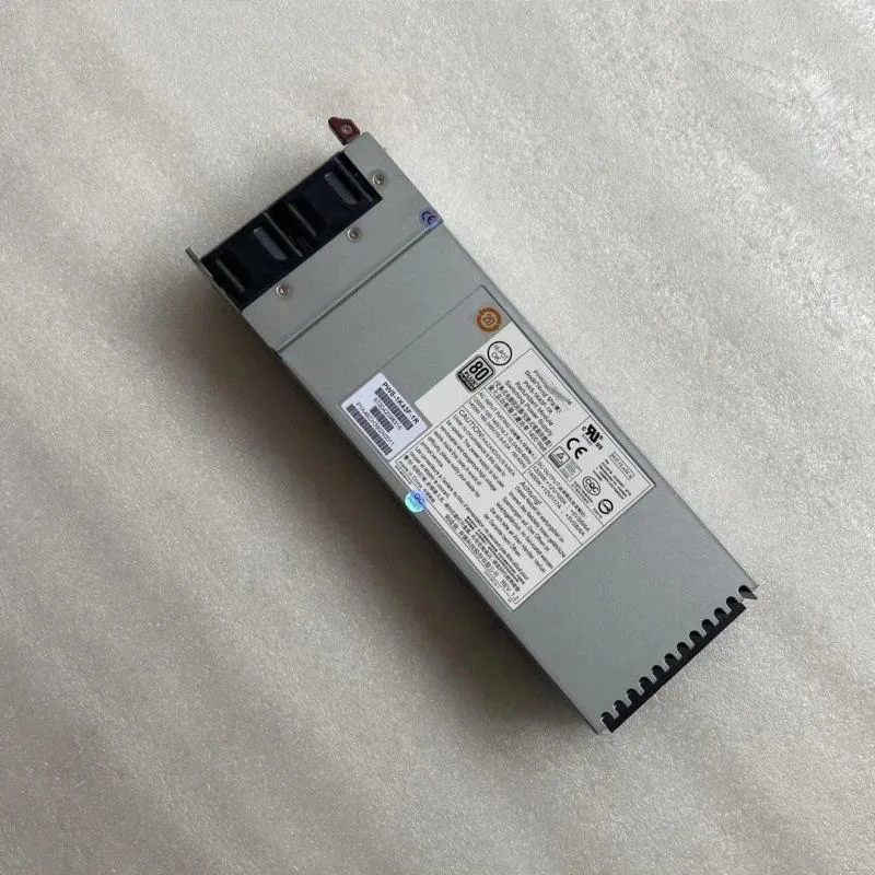 Rectangular silver server power supply unit with ventilation grille and model labels