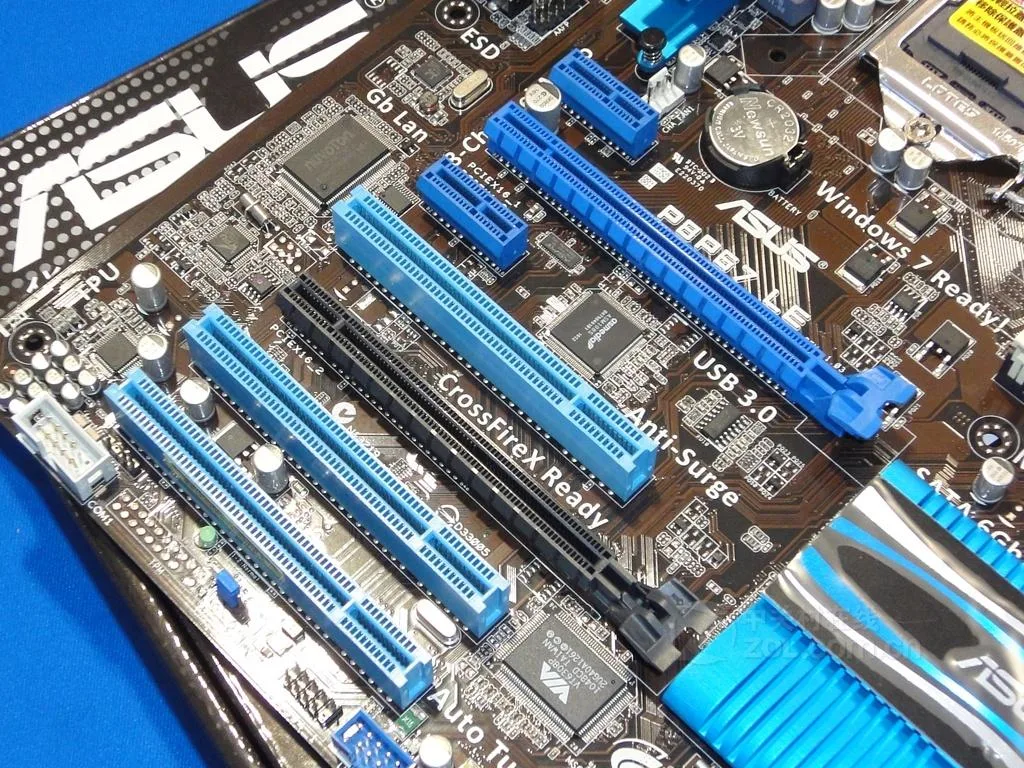 Green ATX motherboard with black sockets and silver heatsinks