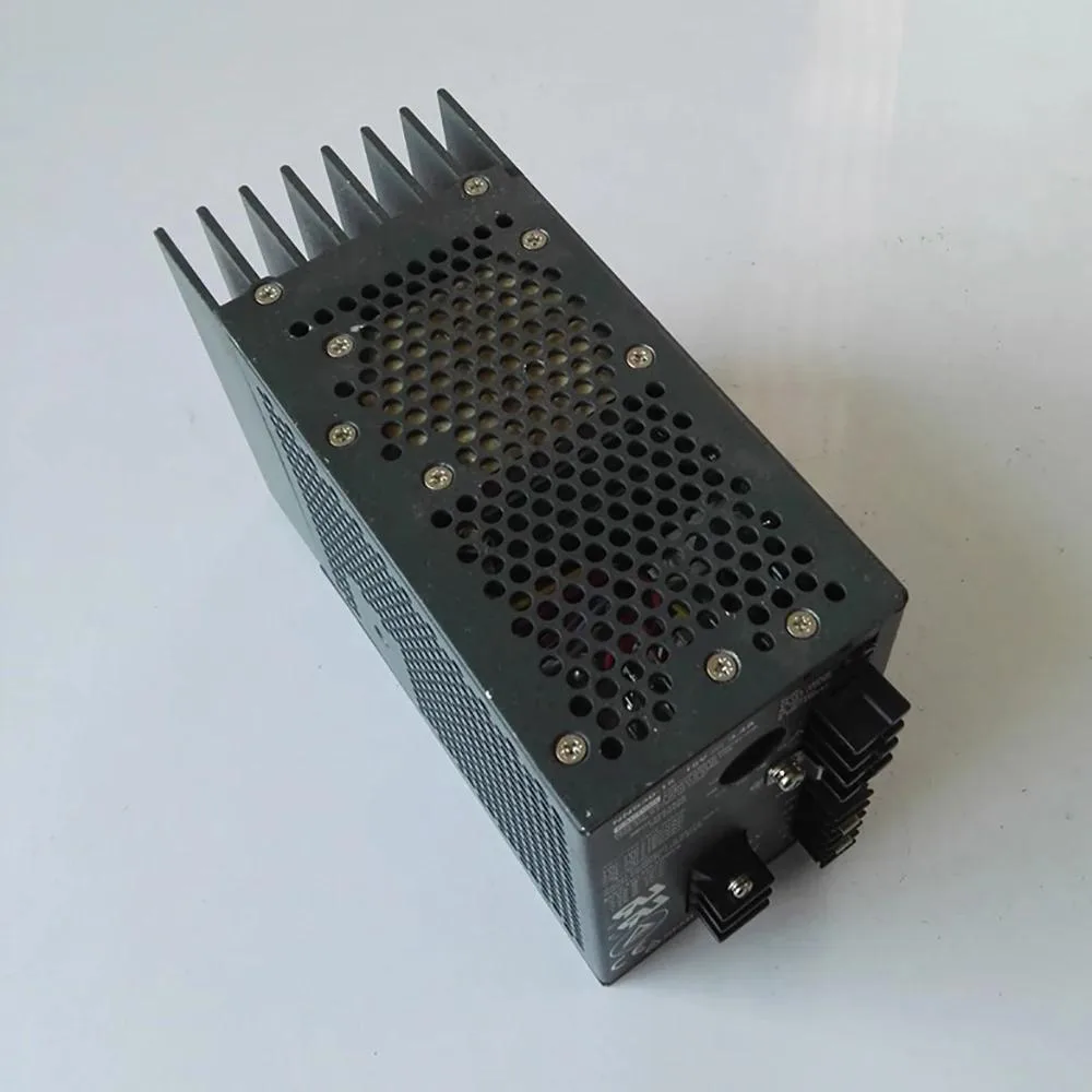 Rectangular metal power supply unit with ventilation slots and front panel controls