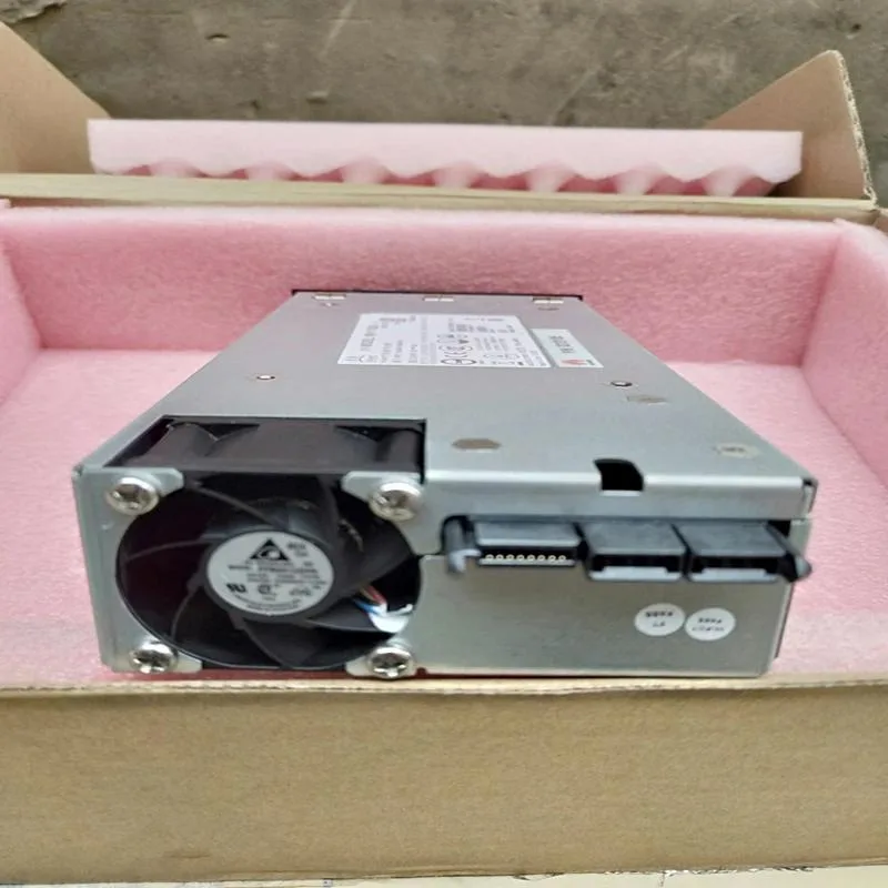 Silver metal ATX power supply unit with fan grille and cable bundle