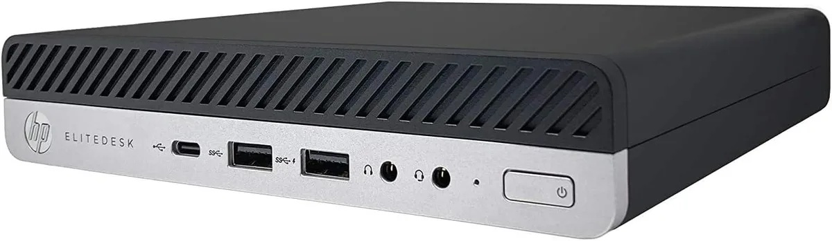 Compact black small-form-factor desktop tower, matte finish, front power button and USB ports