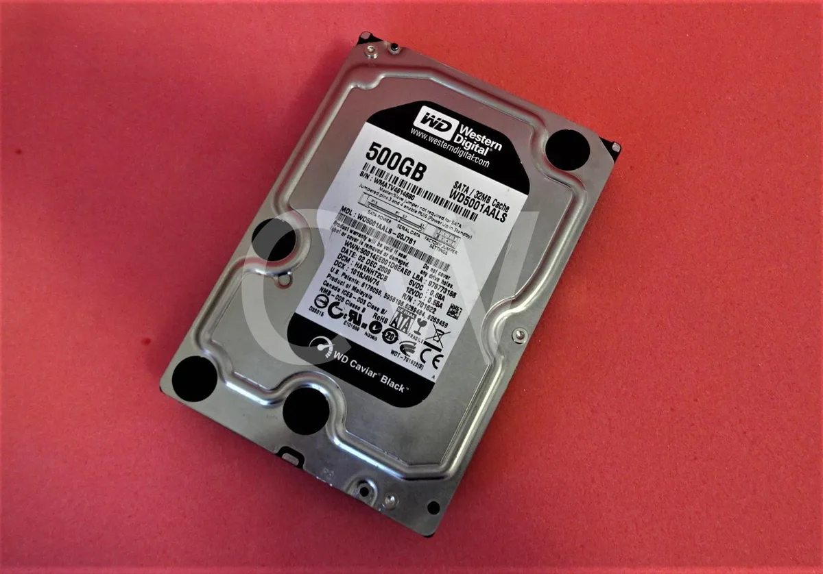Silver 3.5 inch bare SATA hard drive with circuit board visible