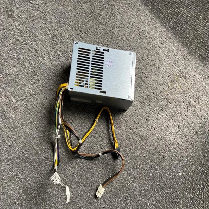Rectangular metal ATX power supply unit with fan grille and cable bundle