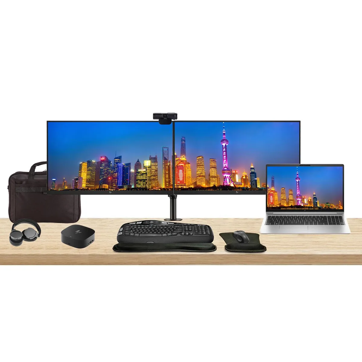 Silver laptop, two black monitors on dual stand, dock, keyboard, mouse, webcam, headphones, briefcase