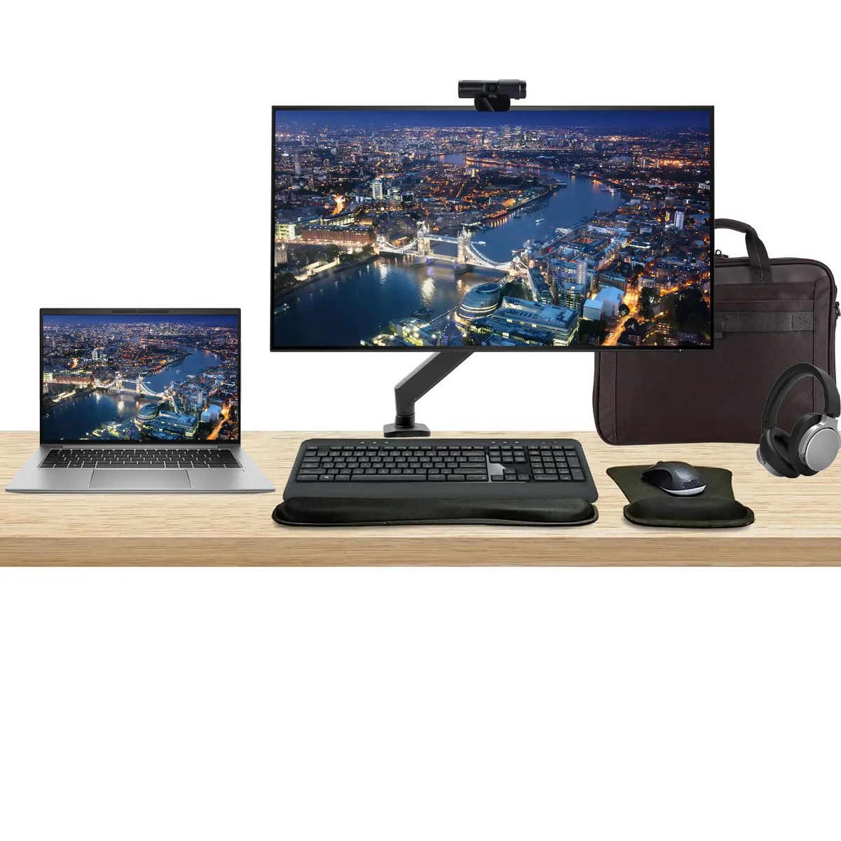 Silver 14 inch touchscreen laptop beside 32 inch 4K monitor with desk mount keyboard mouse webcam headphones and briefcase