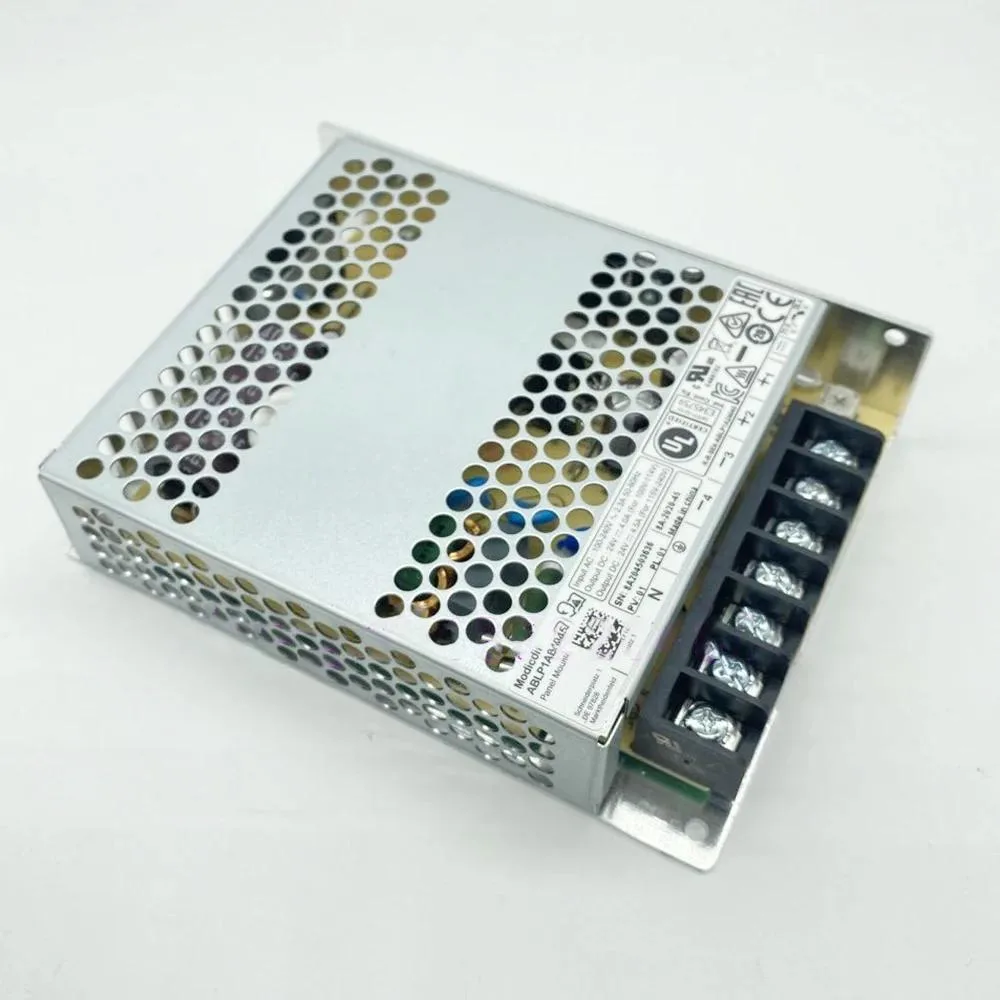 Rectangular metal power supply unit with ventilation slots and terminal connections