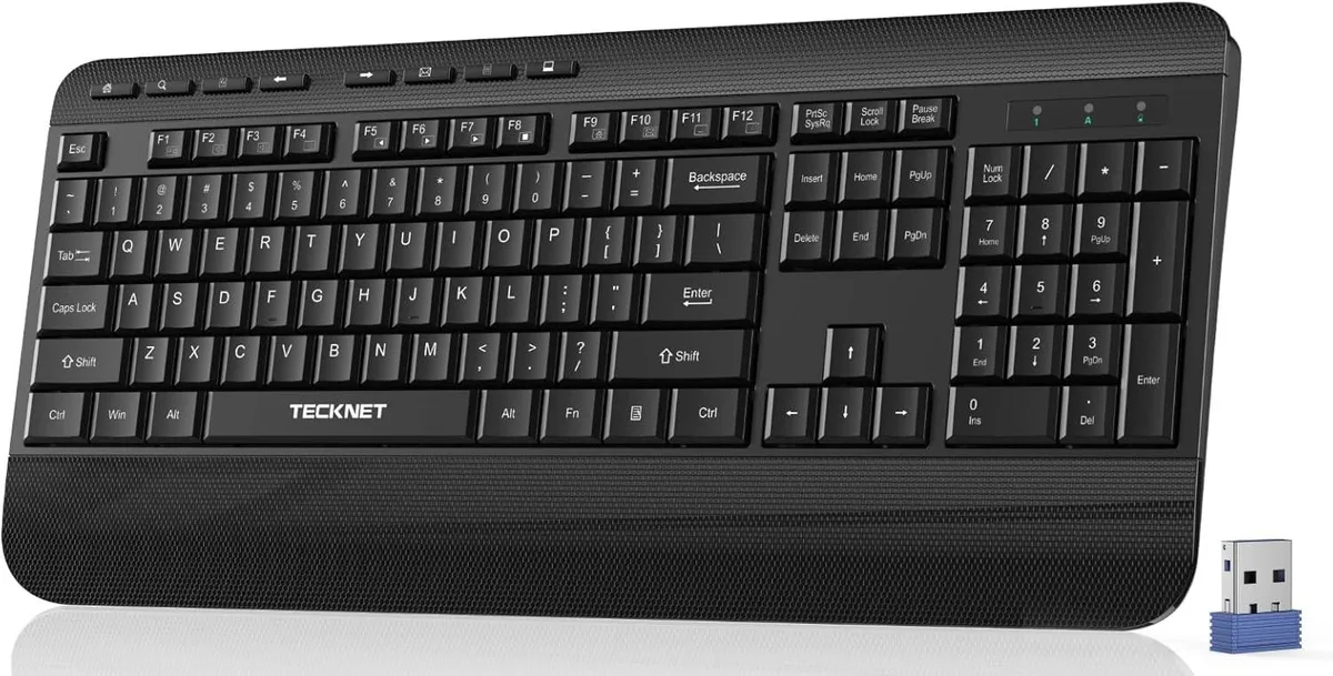 Full-size wireless keyboard with integrated palm rest, matte black finish, low-profile keys and fold-out feet