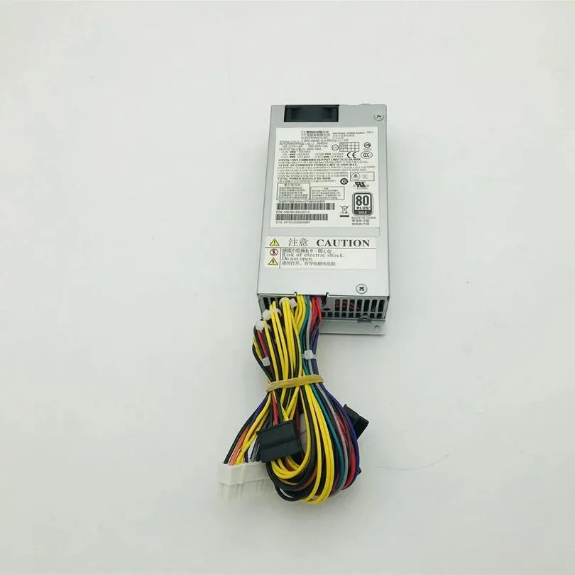 Silver rectangular ATX power supply with fan grille and cable bundle