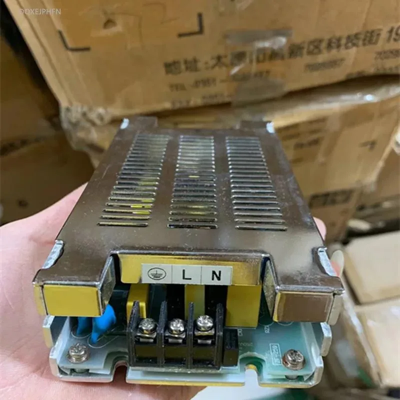Rectangular ATX power supply unit with matte black metal casing and visible cooling fan grille
