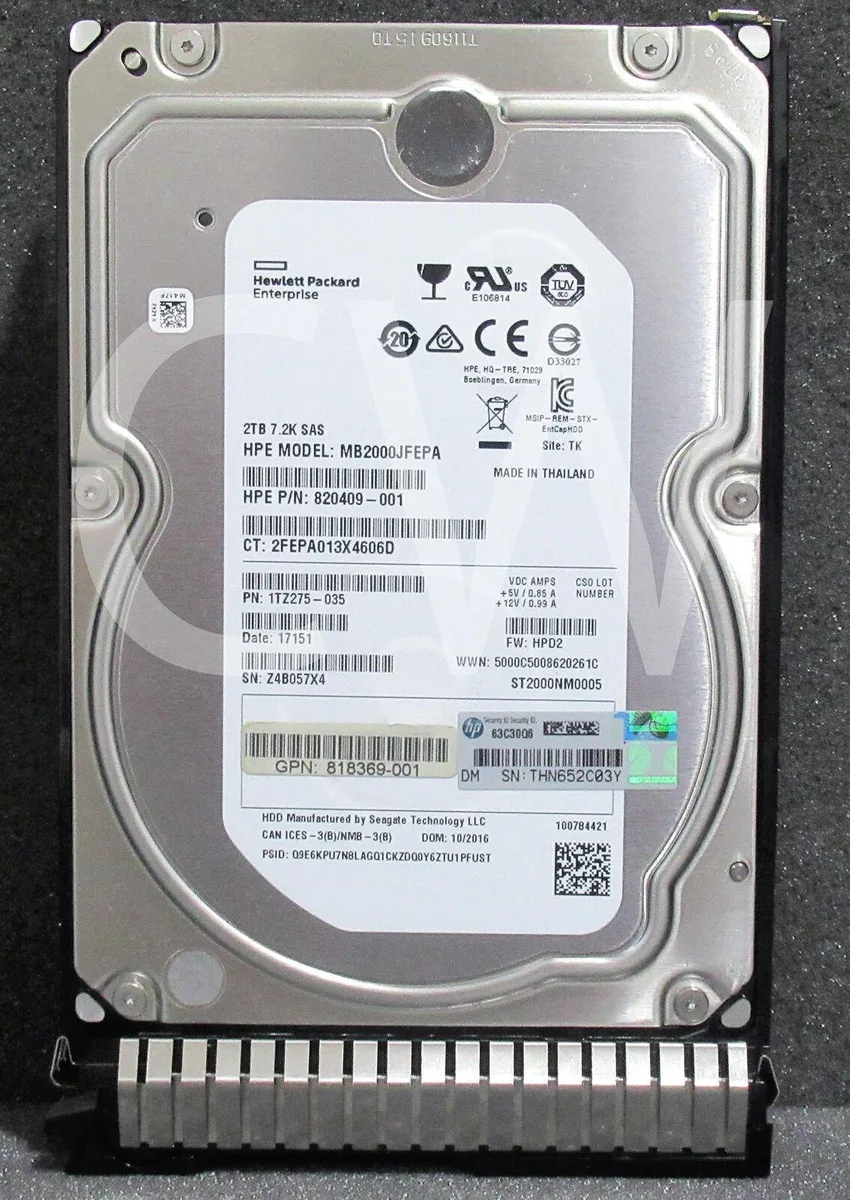 3.5 inch SAS hard drive in silver metal caddy with green pull tab