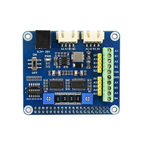 Green rectangular circuit board with 40-pin header, two black DRV8825 driver chips, blue potentiometer, white DIP switch block