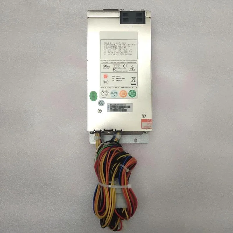 Compact silver 1U ATX power supply unit with rear fan grille and cable bundle