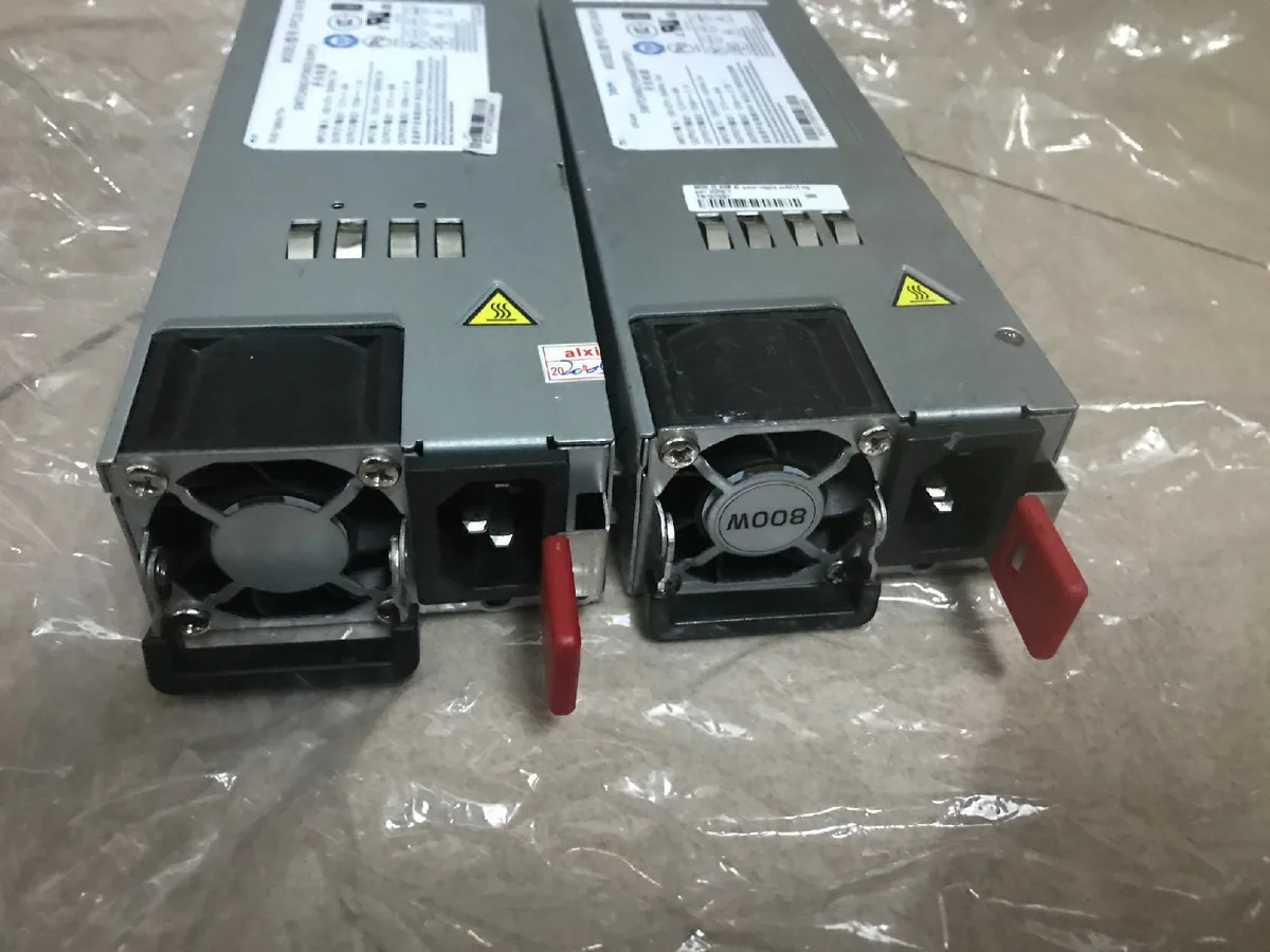 Rectangular silver server PSU with rear fan grille and power connector