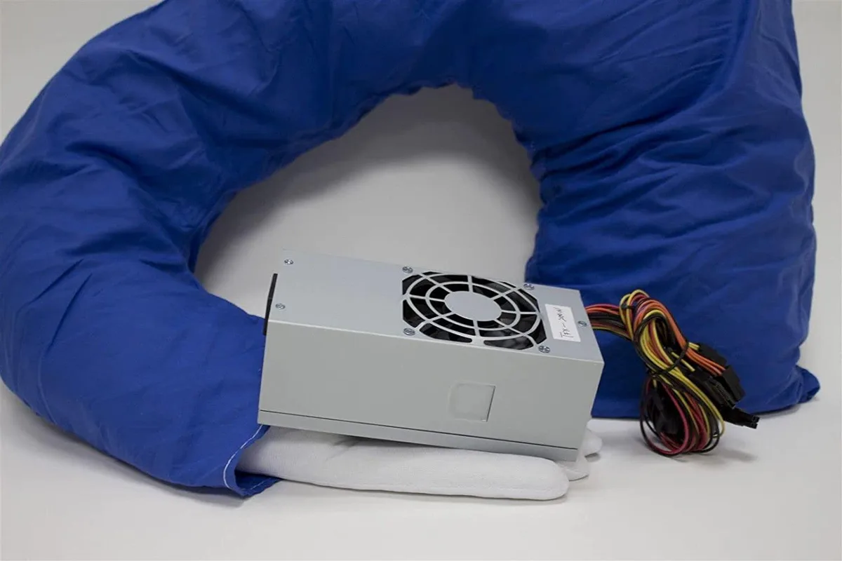 Compact TFX power supply in matte black finish with 80mm cooling fan and multiple cable connectors