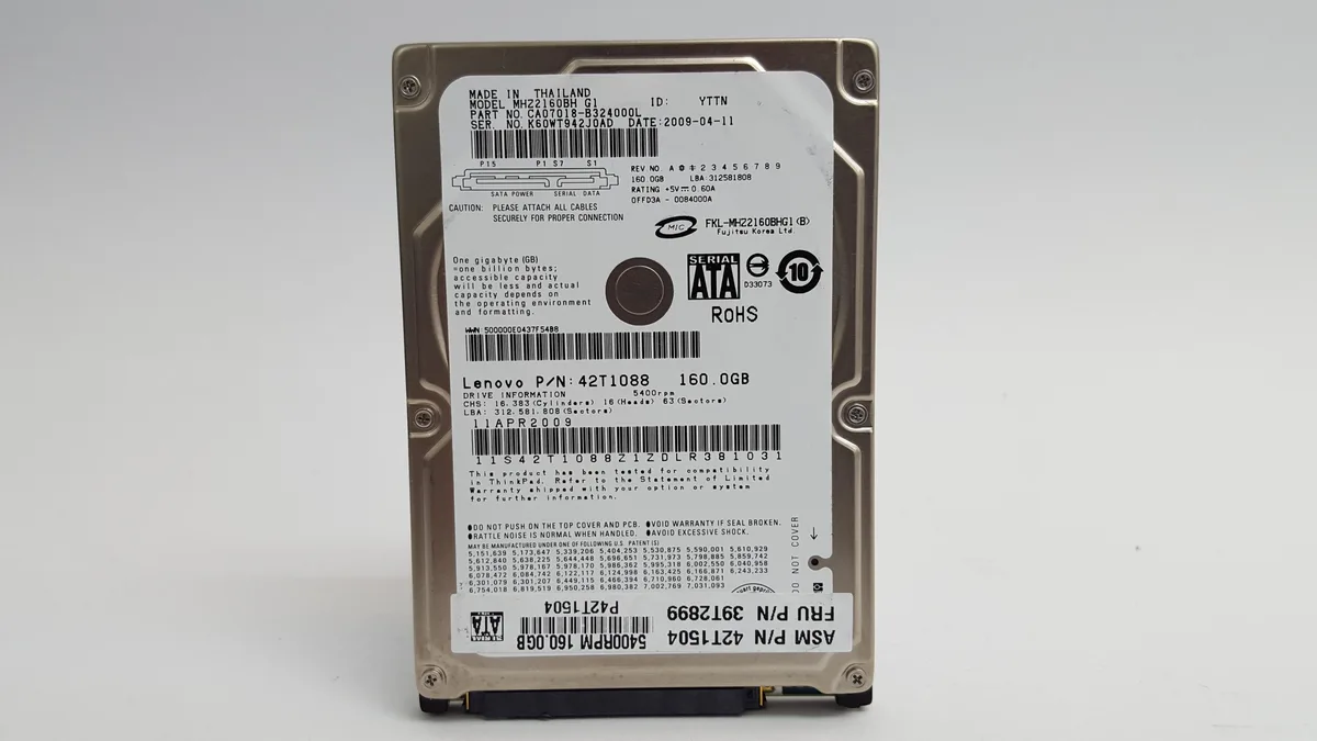 Silver 2.5 inch SATA hard drive with label showing Fujitsu MHZ2160BH G1 160GB