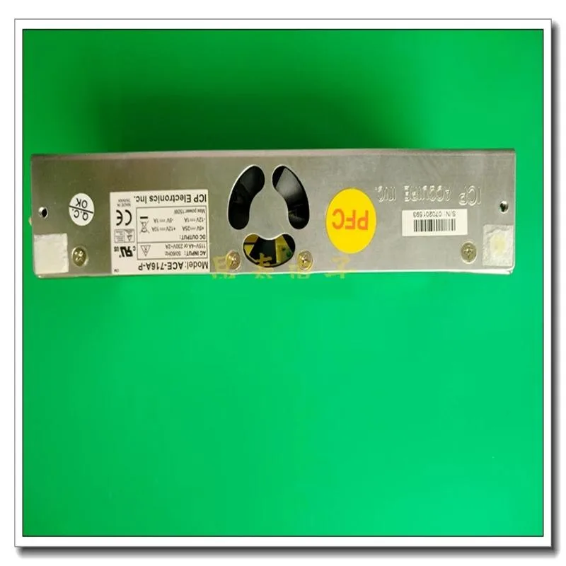 Silver metal ATX power supply unit with ventilation grille and power connectors