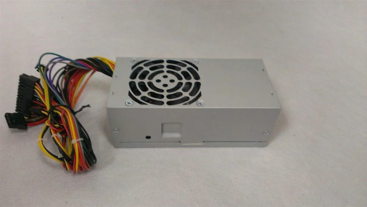 Compact silver TFX power supply unit with 80mm fan and multiple cable connectors visible