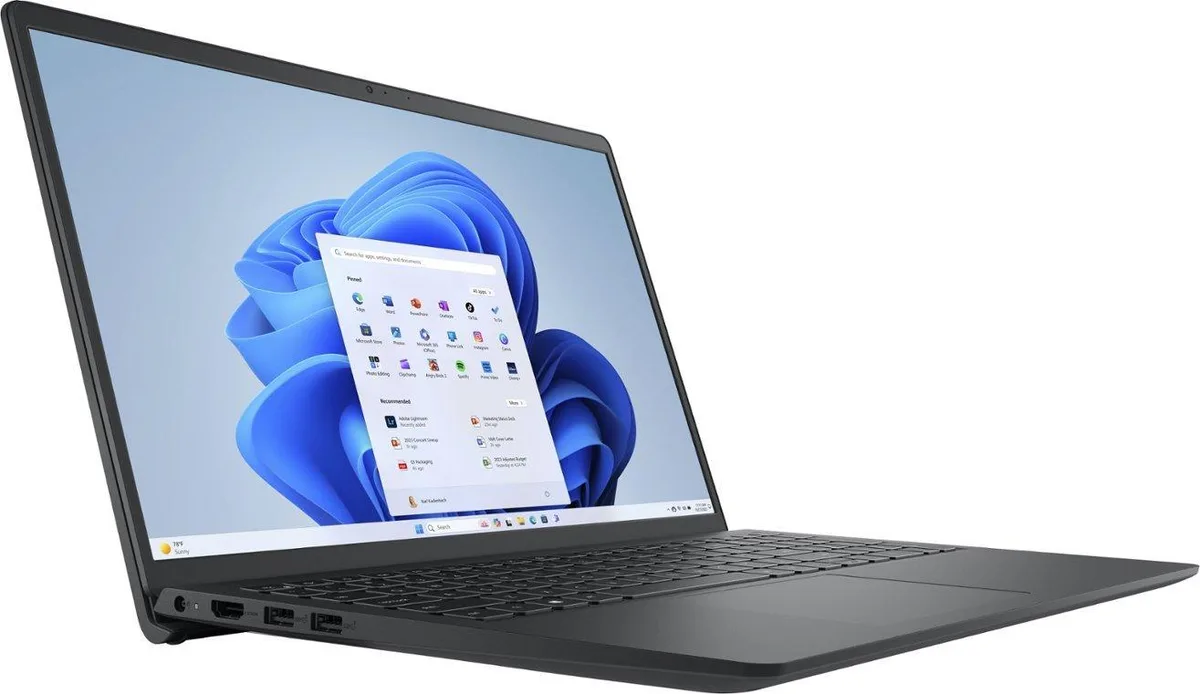 Silver-grey 15.6 inch touchscreen laptop closed on a plain surface