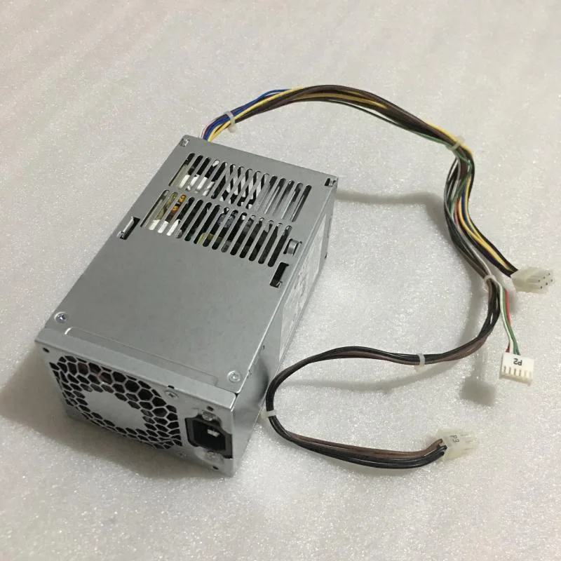Rectangular metal ATX power supply unit with ventilation grille and label showing part numbers 751885-001 and 702308-002