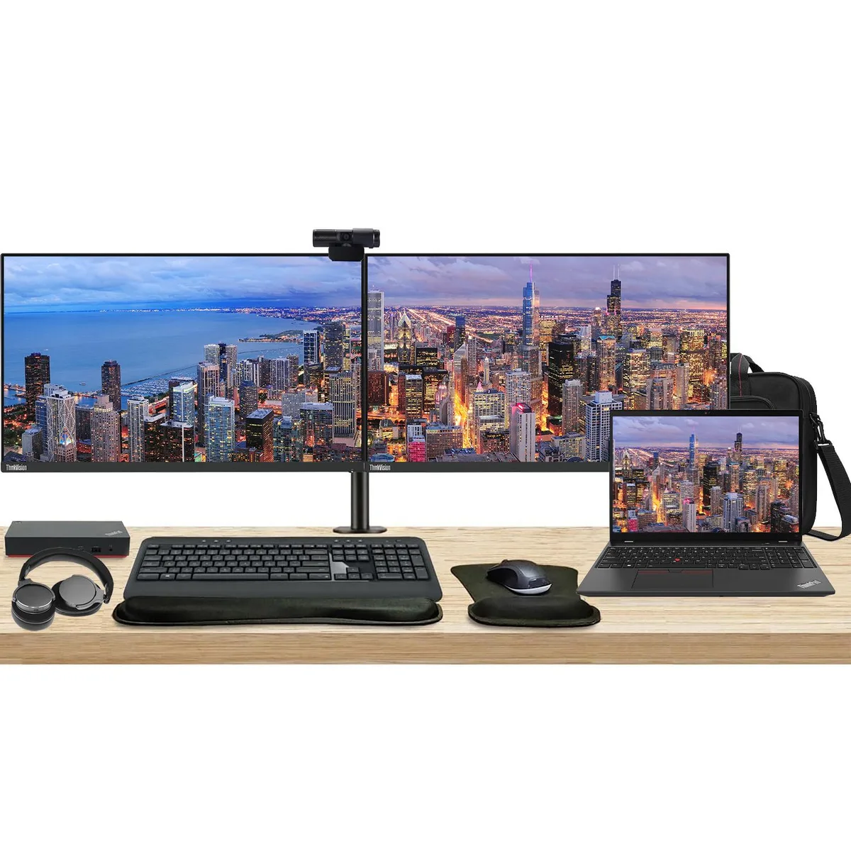 Open ThinkPad T16 laptop beside two 24-inch monitors on a dual-arm desk stand, black matte finish throughout