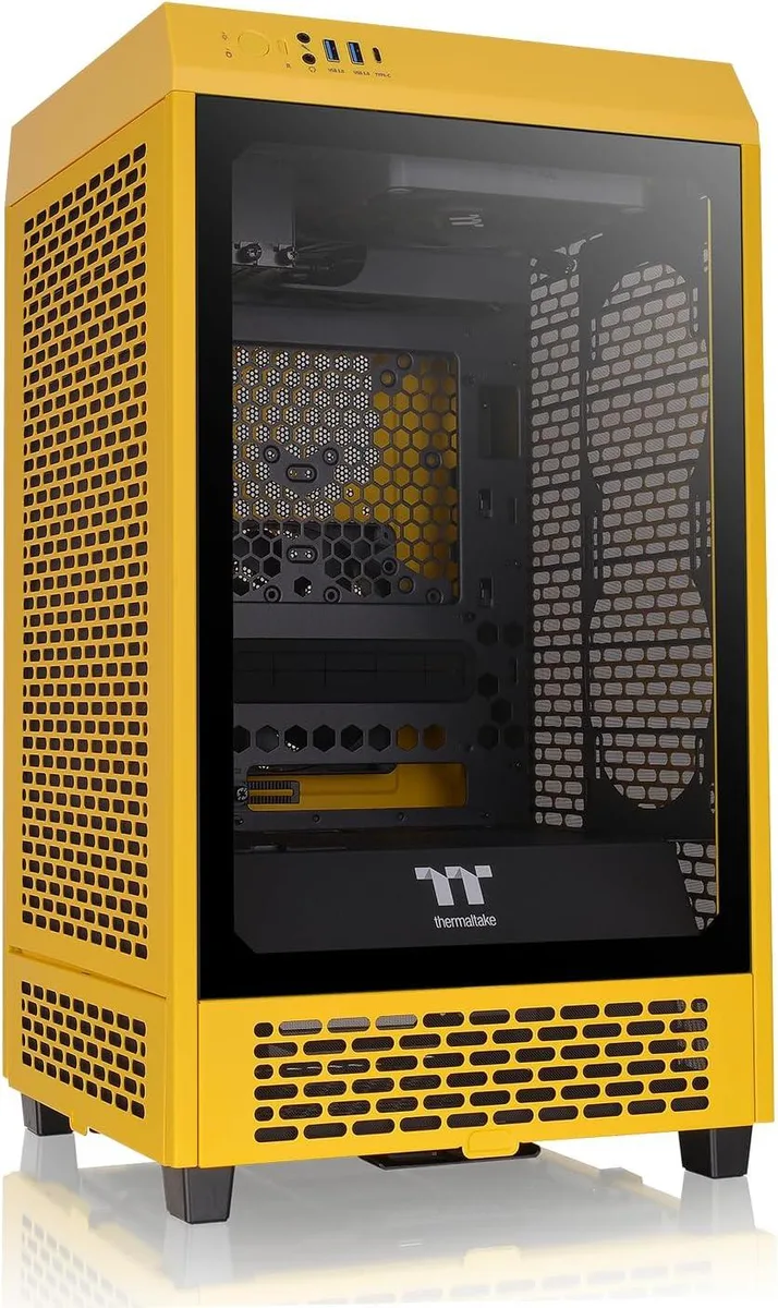 Yellow-and-black Mini-ITX tower case with tempered glass side panel, two pre-installed 140mm fans visible through mesh top and rear